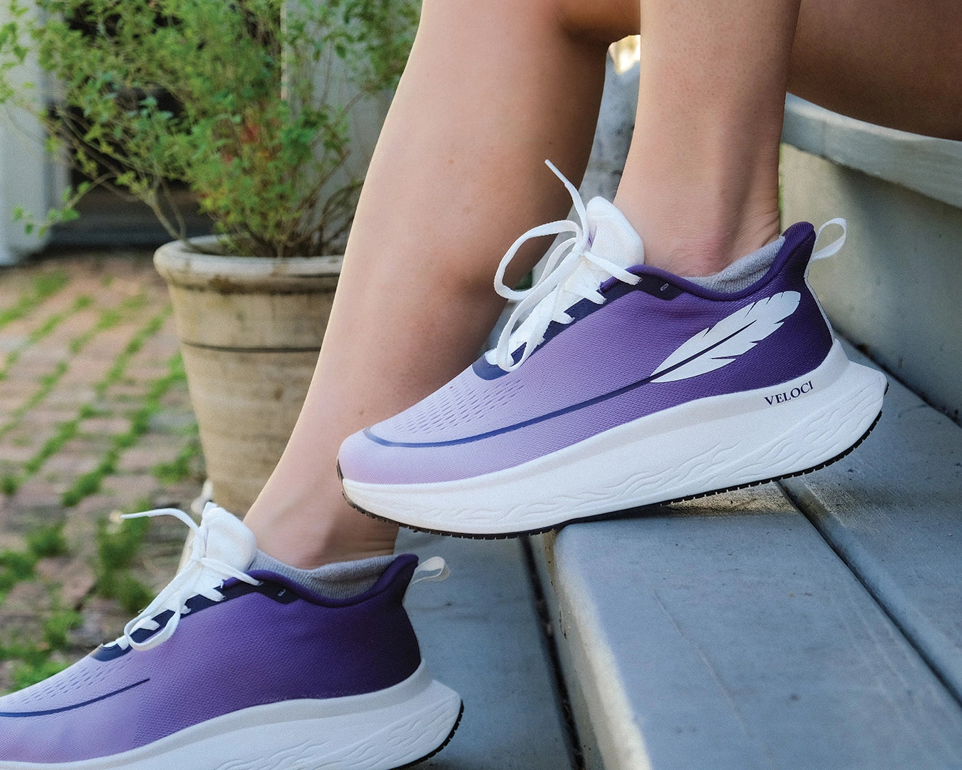 Veloci Men's Ascent running shoe in purple with white midsole, outdoor side profile showing the 10 mm heel drop and breathable upper