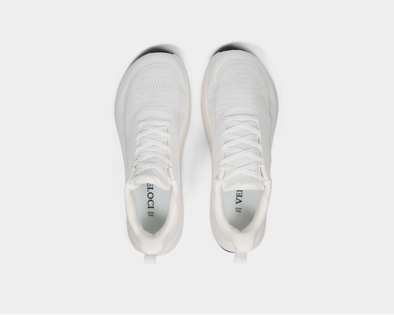 Top-down view of the Veloci Ascent pair in white displaying the spacious toe box and lacing system