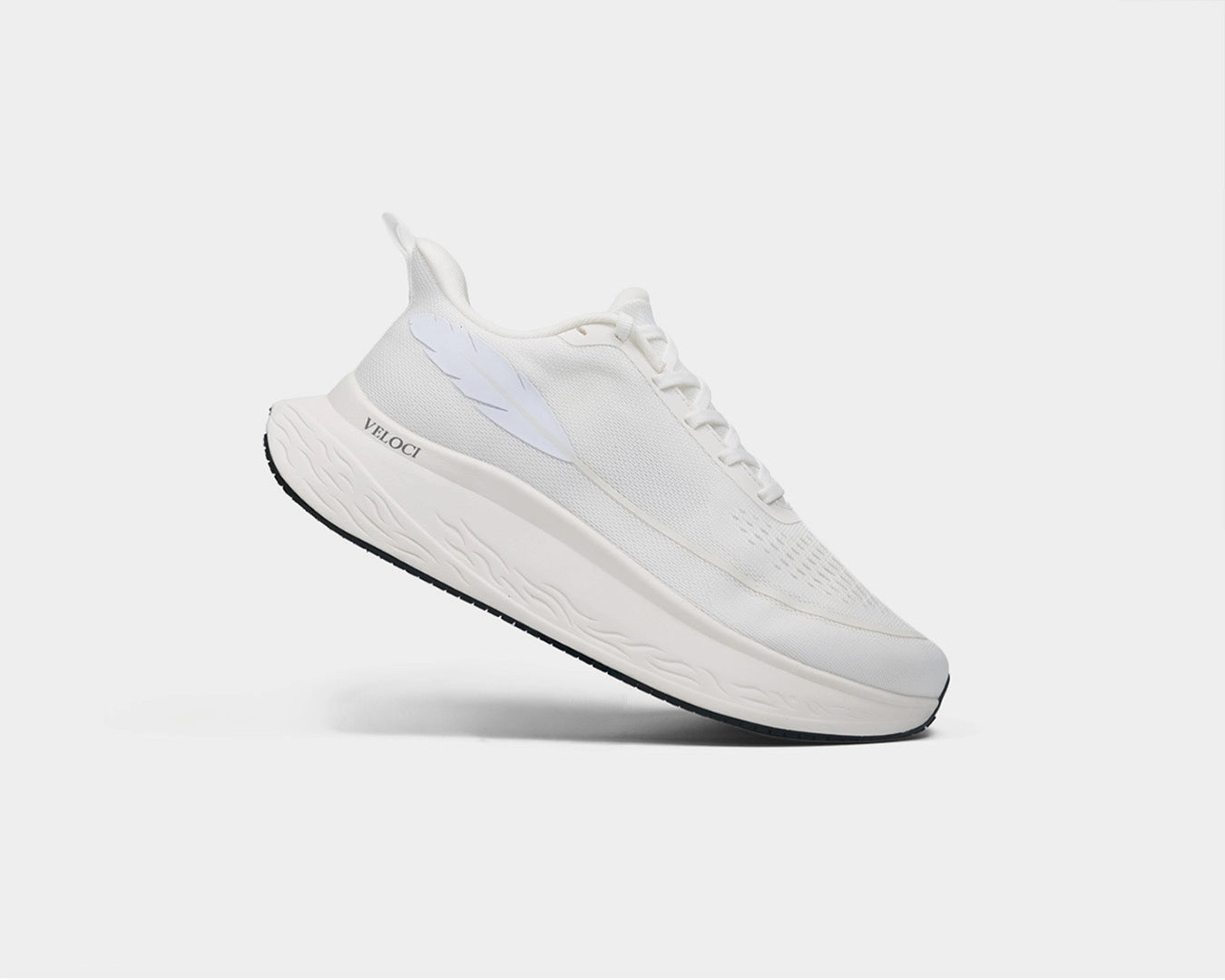 Veloci Ascent running shoe in white with white midsole, side profile showing the wide toe box, supportive foam, and breathable upper