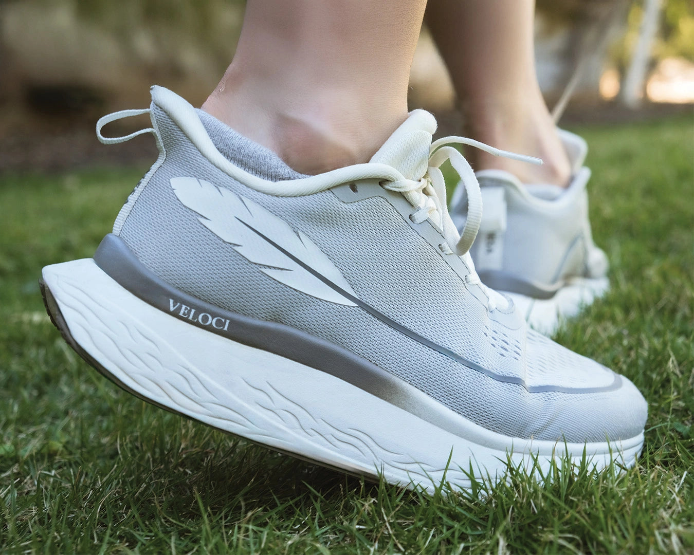 Veloci Mesa stability running shoe in gray with white midsole, outdoor side profile showing the wide toe box, supportive foam, and breathable upper